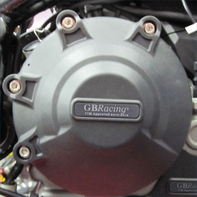 Close-up of a motorcycle engine cover with GBRacing branding.