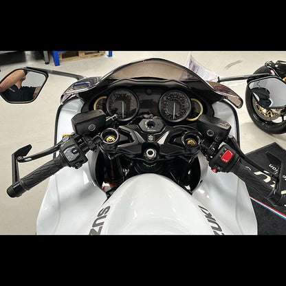Close-up of a motorcycle's dashboard and handlebars with 'Suzuki' branding.
